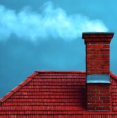 chimney-on-red-tile-roof-with-smoke-against-a-blue-sky-for-home-heating-concepts-photo