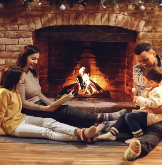 happy-family-parents-with-two-kids-relaxing-by-fir-2023-11-27-04-58-53-utc-scaled